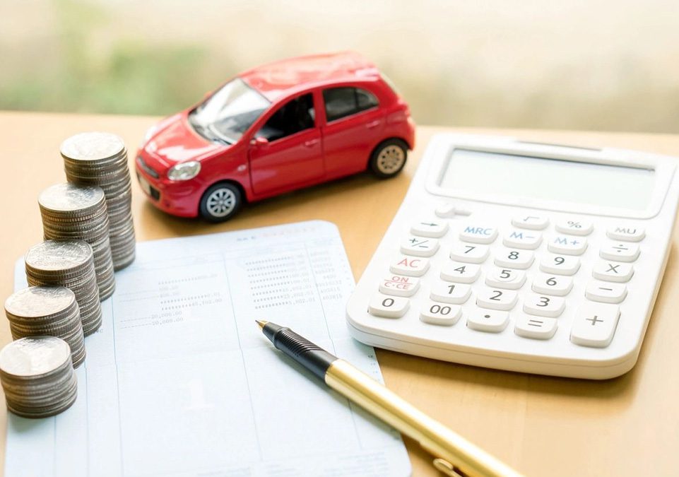 A red car sitting on top of some money.